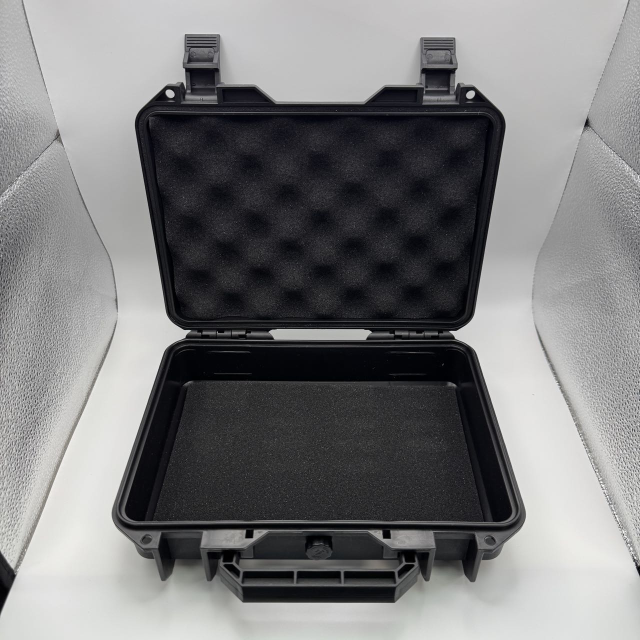 An MK Bullion hard case open, showing the convoluted foam lid and the moulded shell